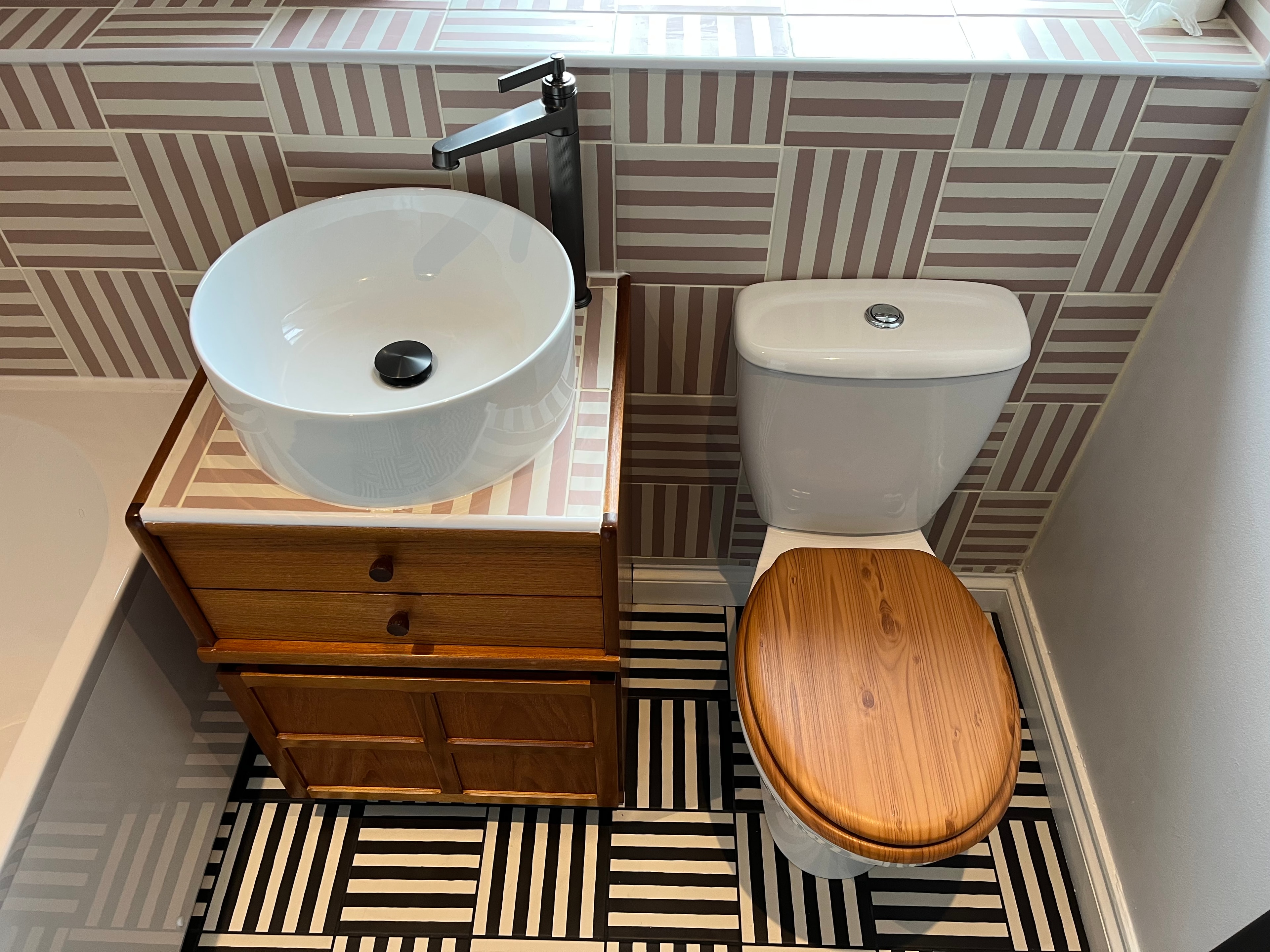 Bespoke upcycled cabinet tiled and tiling to walls and floor