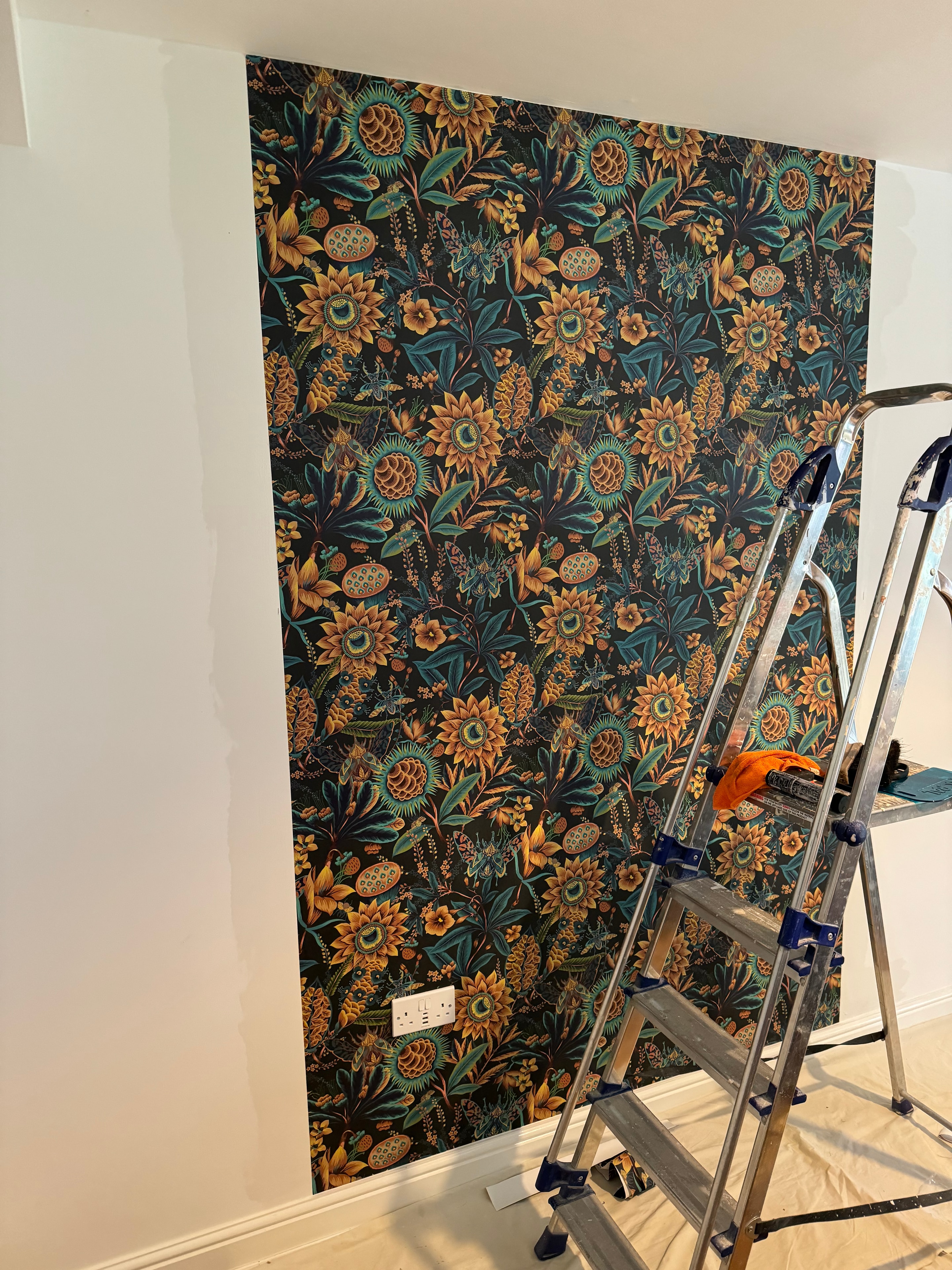 Botanical wallpaper being hung