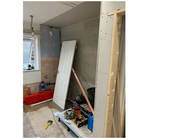 Partition wall removed and wall rebuilt to accommodate shower unit